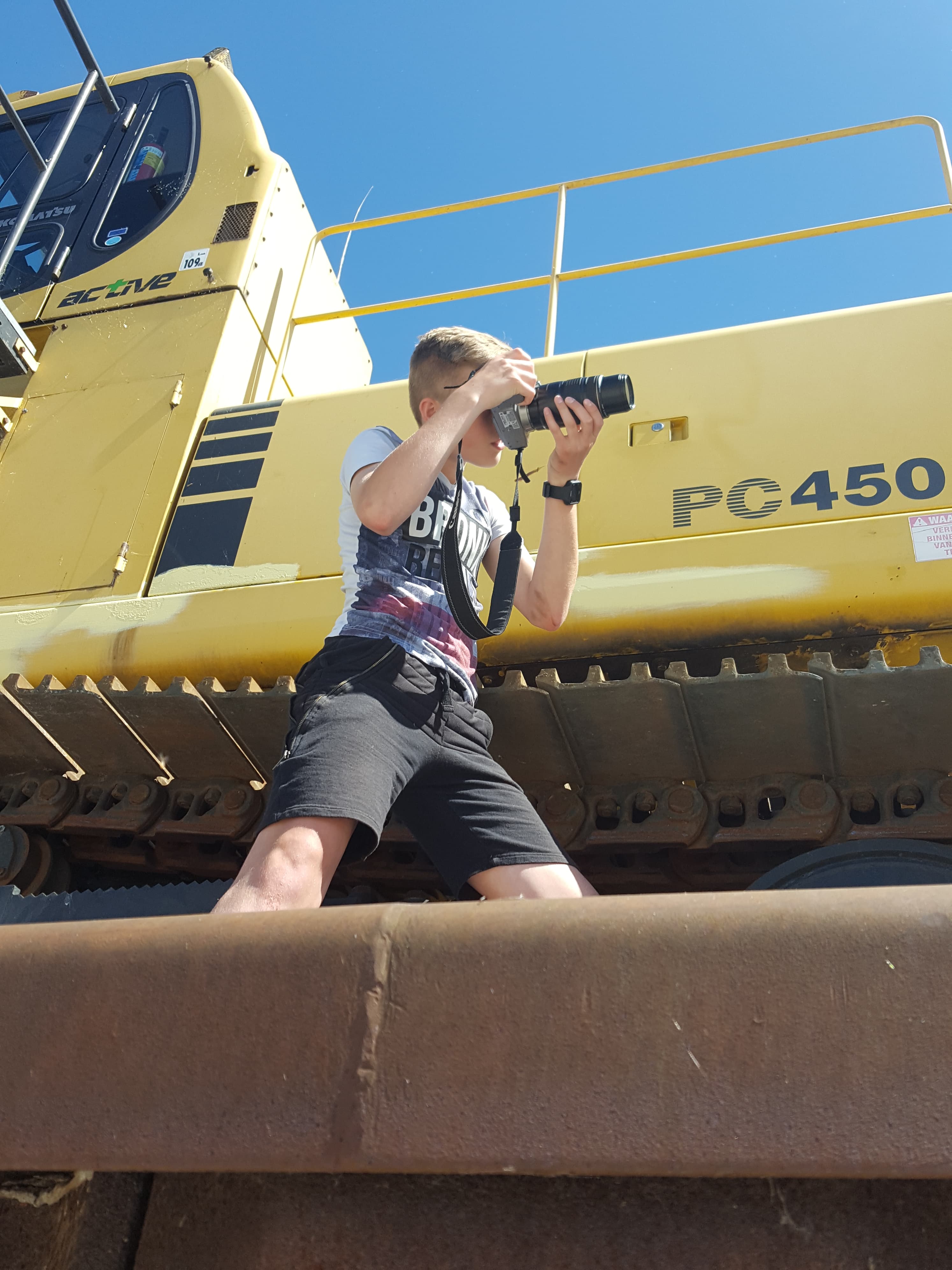 Yannick op zijn 12e, met de camera op een graafmachine